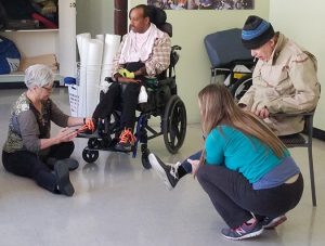 Participants and instructors work through foot excercises