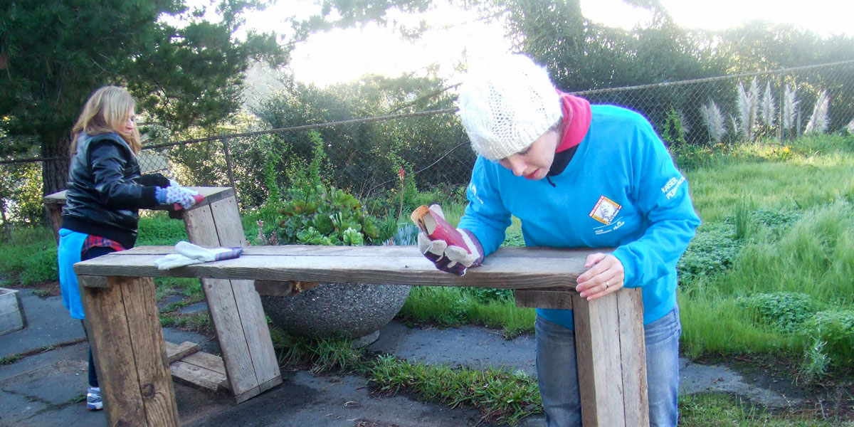 Volunteers work to repair planter beds in the Ability Now Bay Area garden