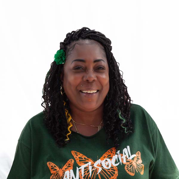 Profile image of LaVon Catherine, an African-American woman with brown skin and curly black hair laced with colorful extensions.