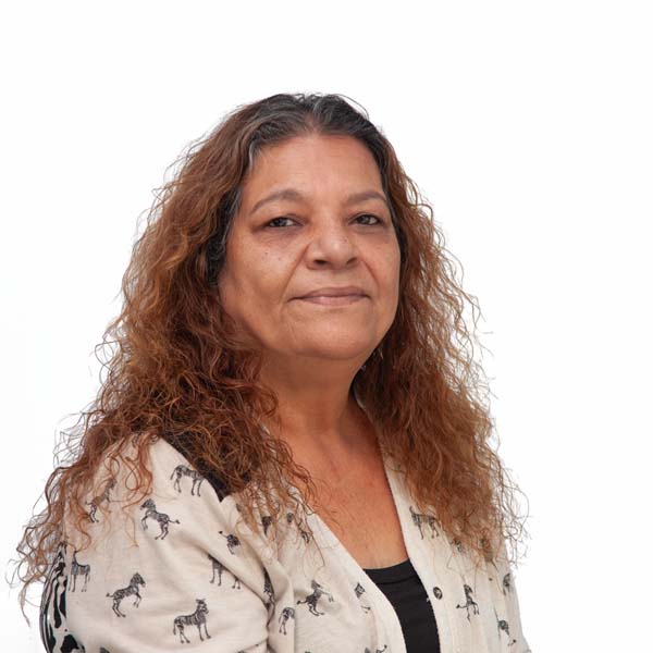 Profile image of Mildred Nieves, a Puerto Rican woman with dark skin, long wavy brown hair and brown eyes.