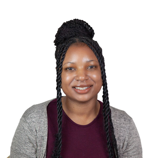 Headshot of Markishea, a smiling Black woman dressed in burgundy and grey with her thick braids mostly gathered in a bun.
