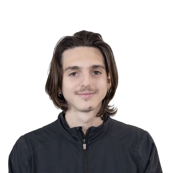 Headshot of Michael Creekbaum, a White man with shoulder-length brown hair and a thin van dyke goatee. He is wearing a black zip-up jacket.